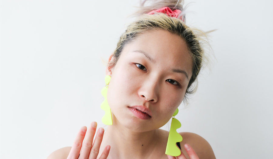 Woman in neon yellow earrings