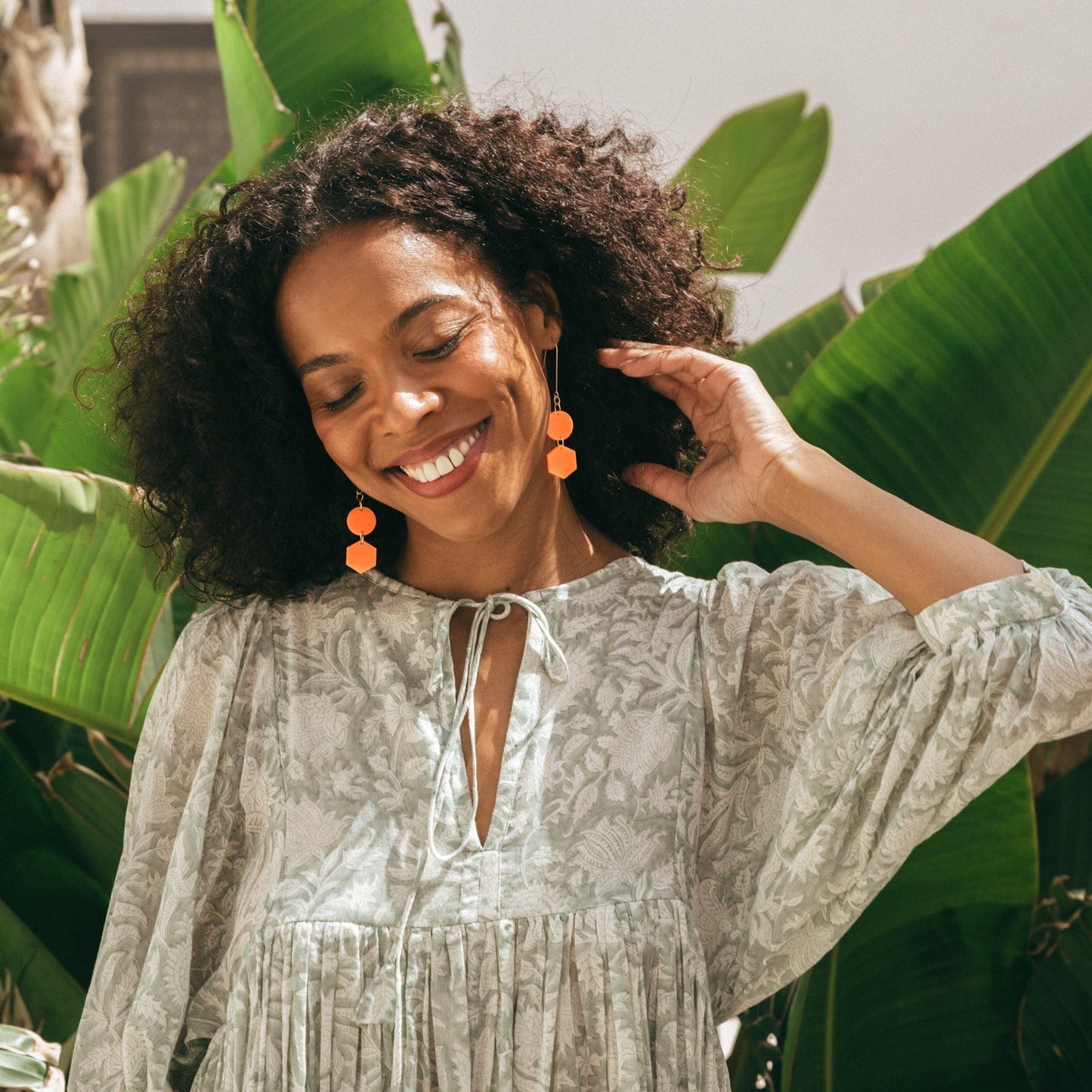 Elegant, elongated and lightweight Belle Dangles geometric dangly earrings in bright neon orange #color_neon-orange