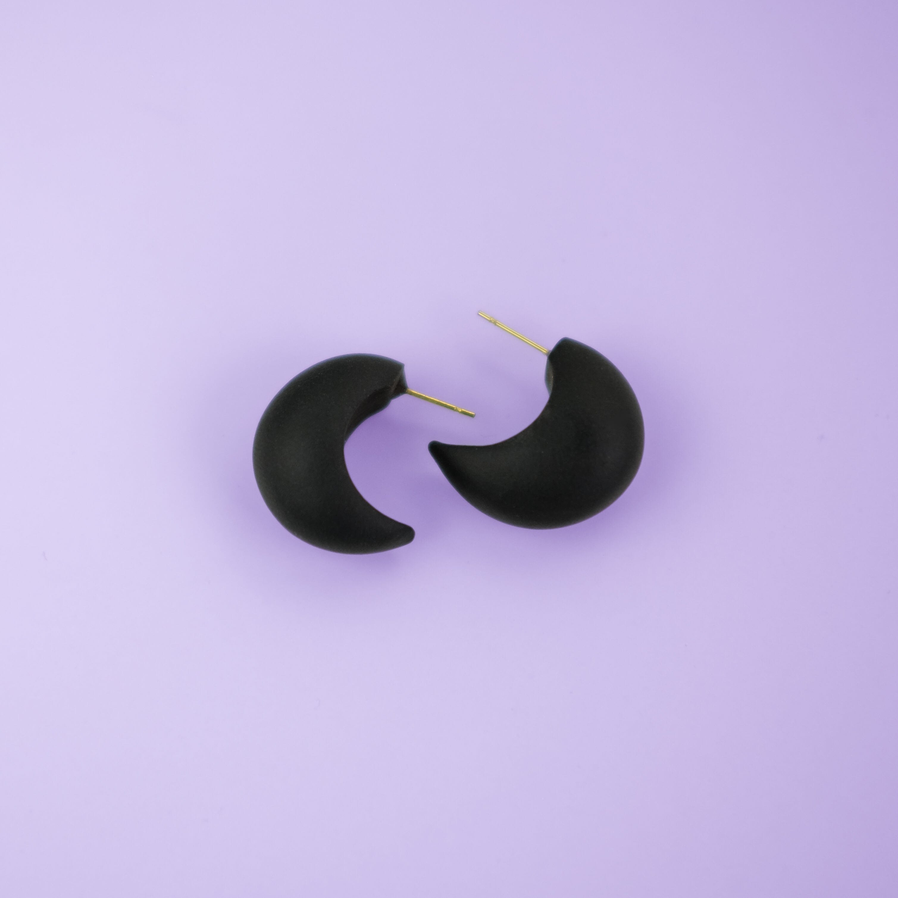 Chunky chubby huggie hoops earrings, statement studs in Black #color_black
