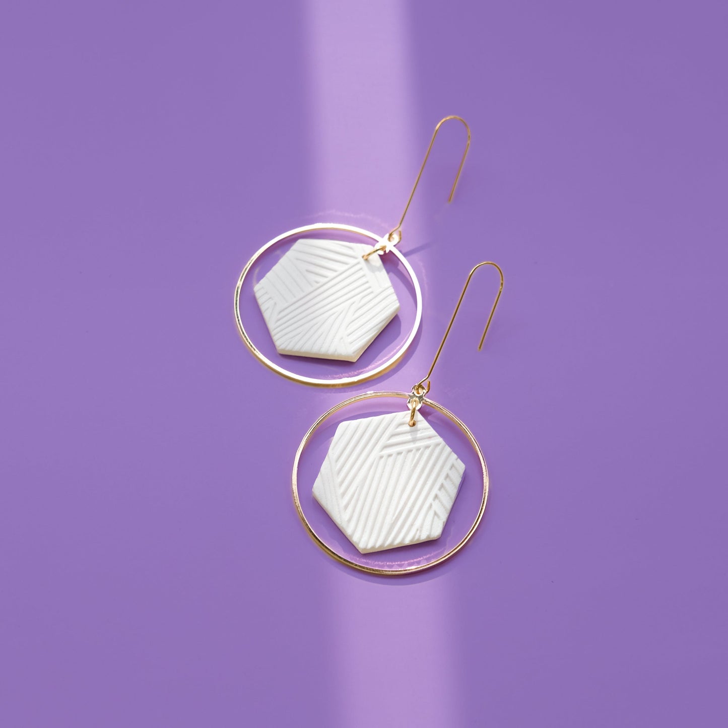 Hex Halo Dangly hexagon shaped elegant and lightweight white and gold earrings #color_white-textured-lines