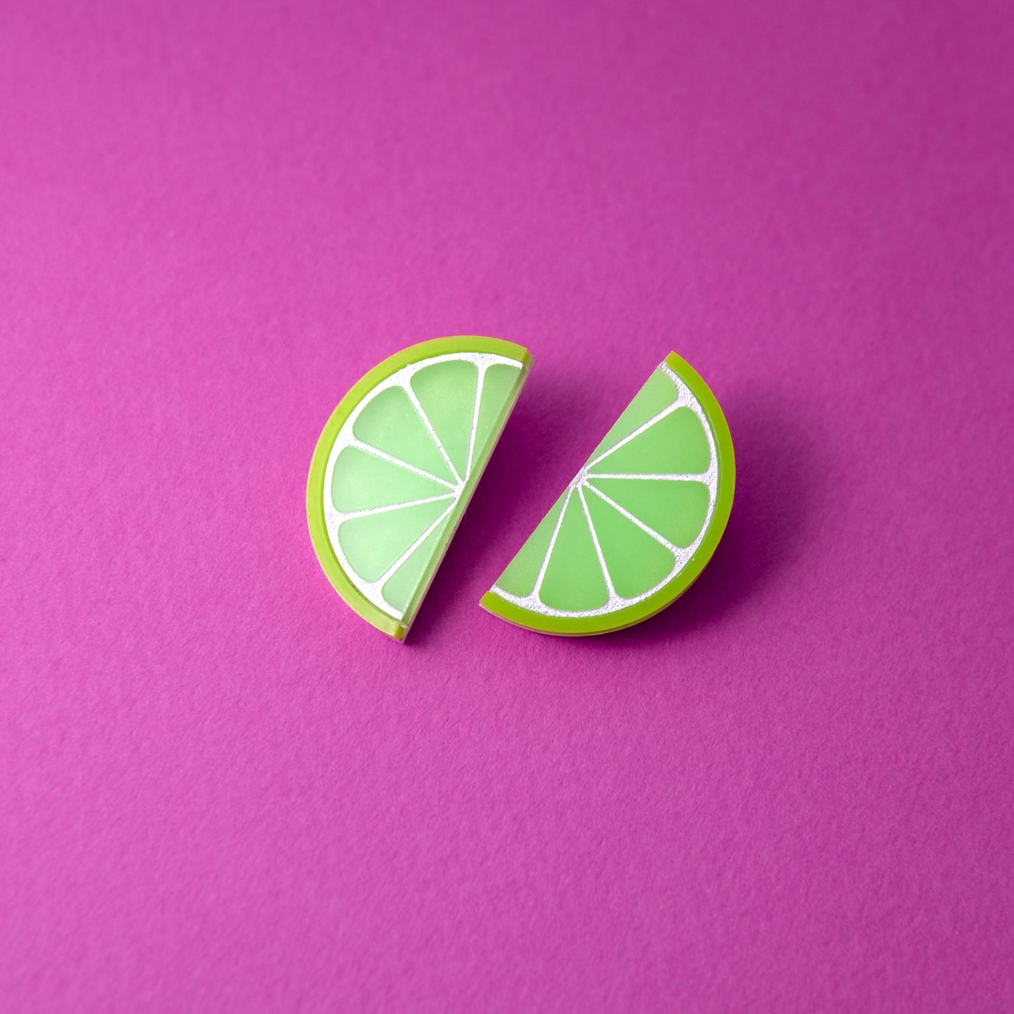 Lime slice stud earrings, glossy, lightweight, playful, citrus half-moons with white segment lines #color_green-white