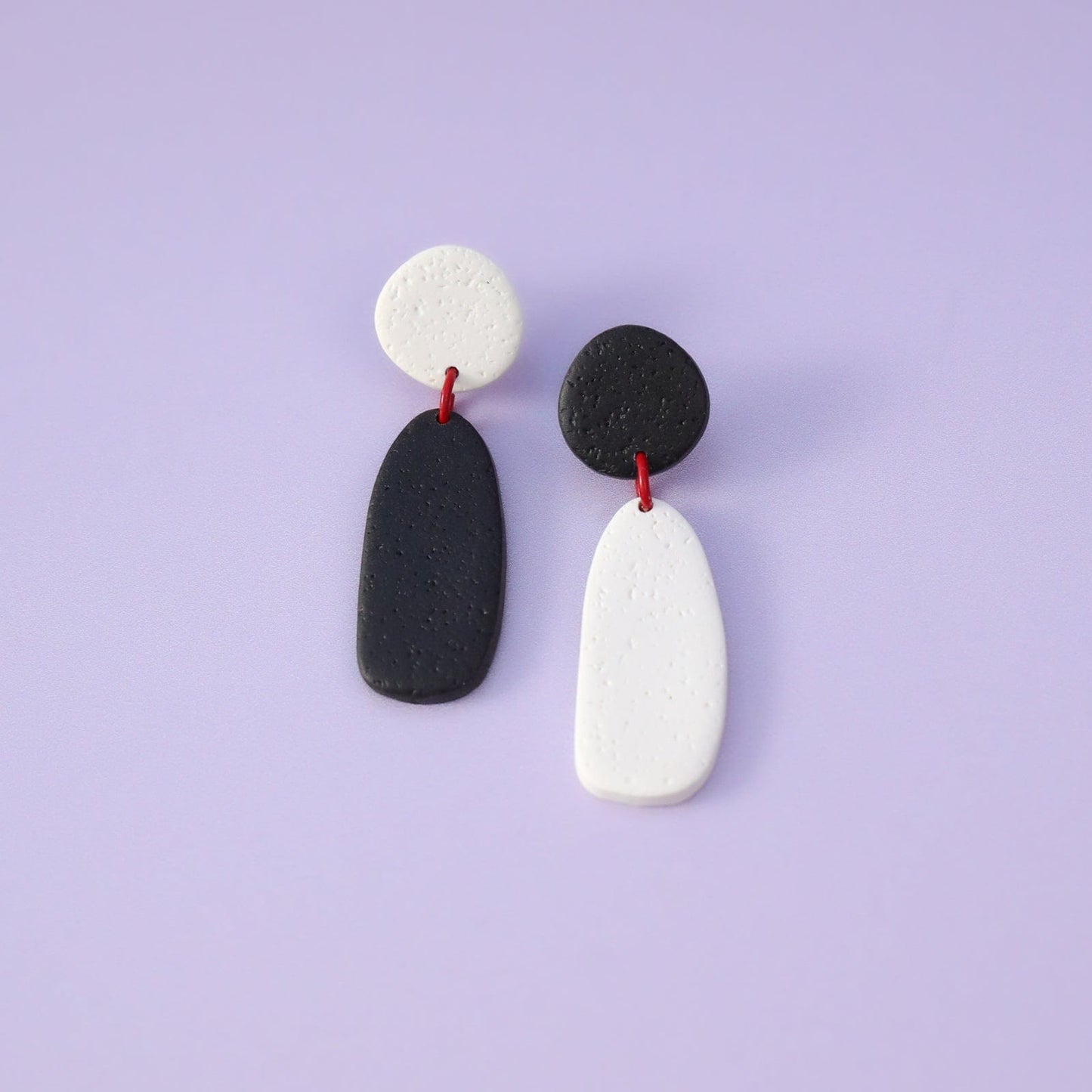 Artsy black and white Miro inspired lightweight dangly earrings with red accents #color_black-and-white