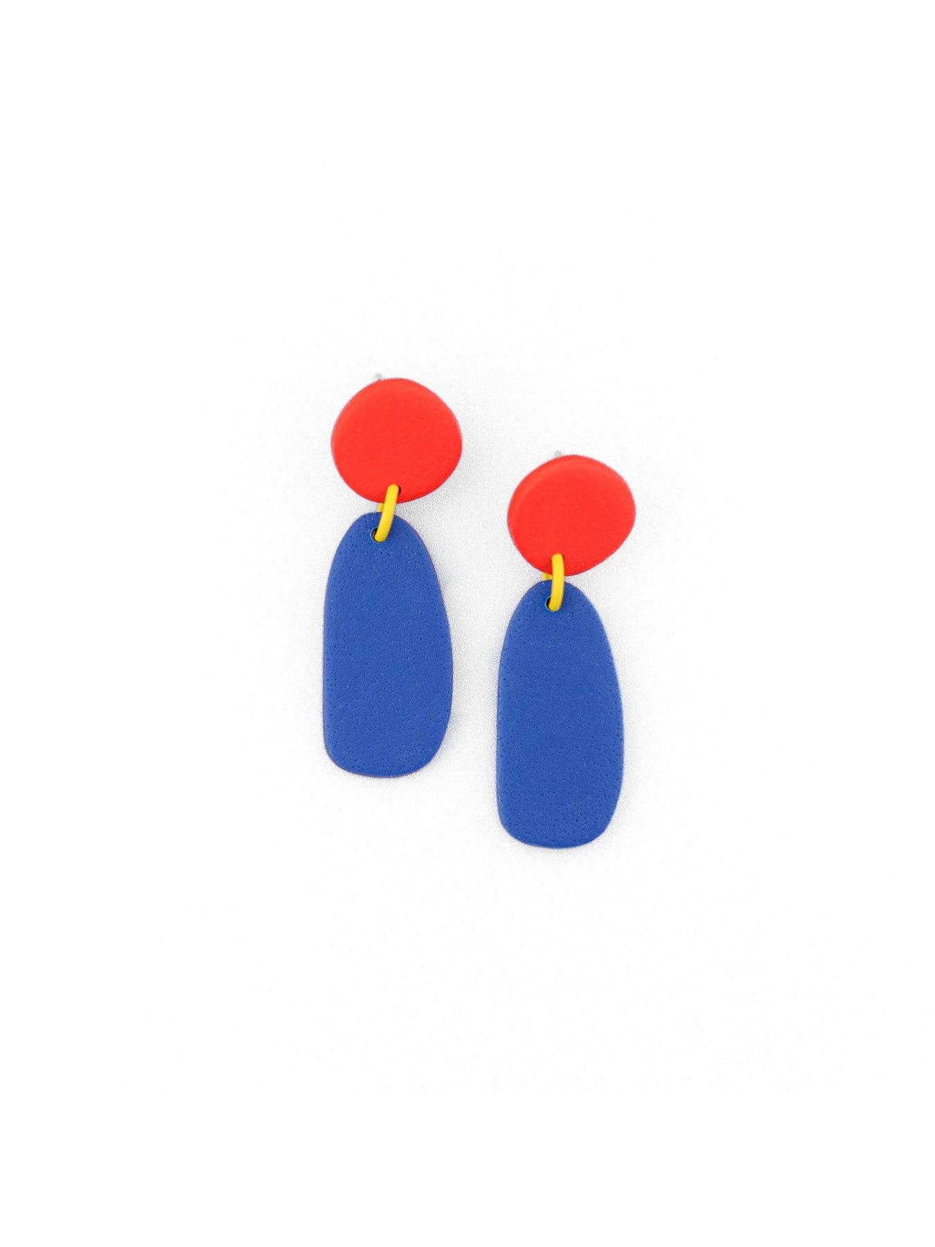 Red top with blue elongated drop earrings, smooth matte, airy, playful, tiny yellow connector detail #color_red-blue