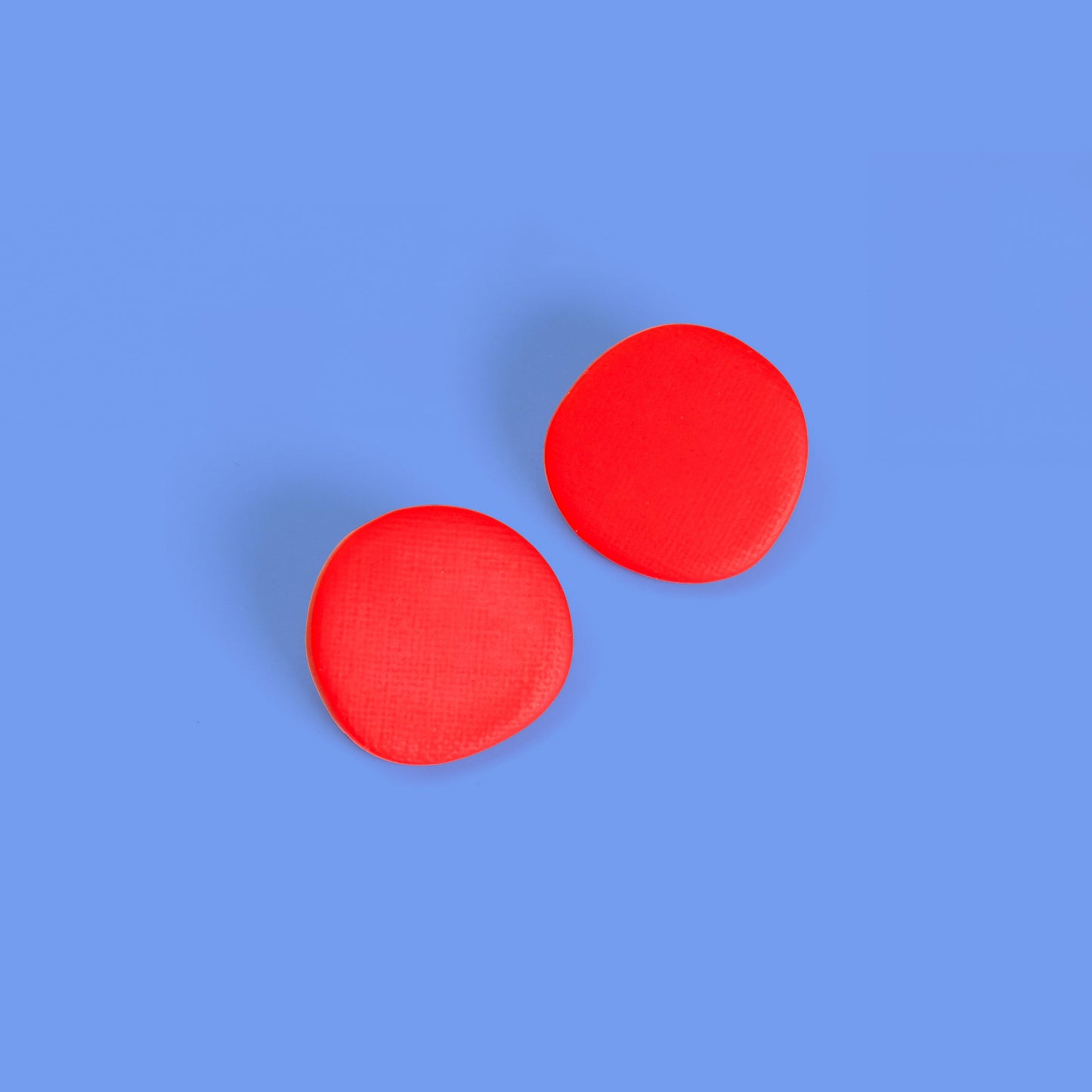 Miro inspired organic round shaped studs with canvas texture in red #color_red