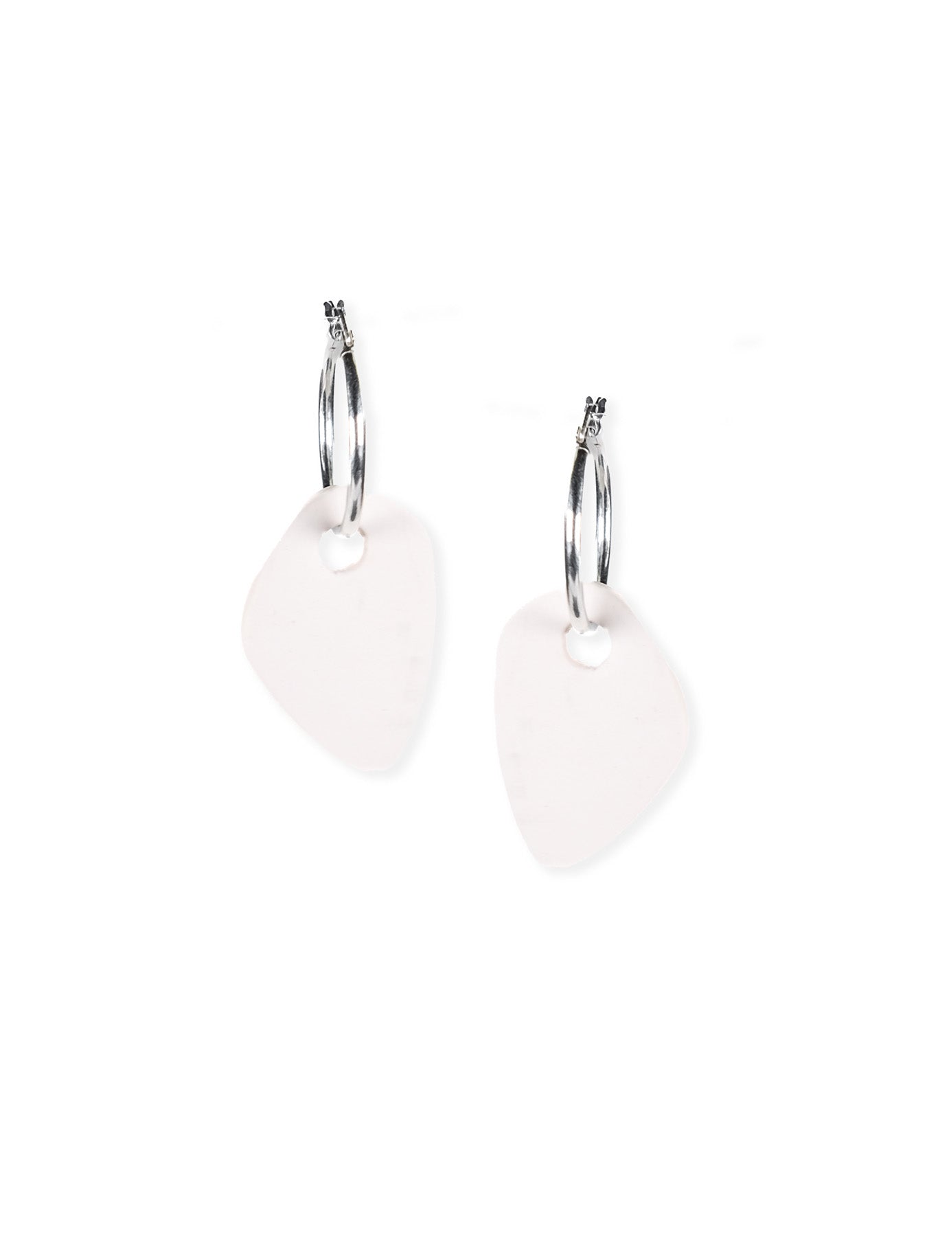 White abstract drop earrings, satin-matte, airy, rounded triangular shape, small circular cutout on silver hoops #color_white