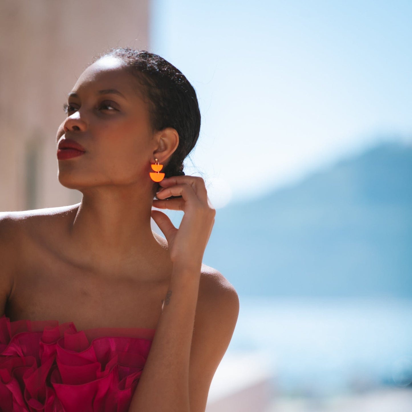 Twin Luna cute dangly half-moon shaped earrings in neon orange #color_neon-orange