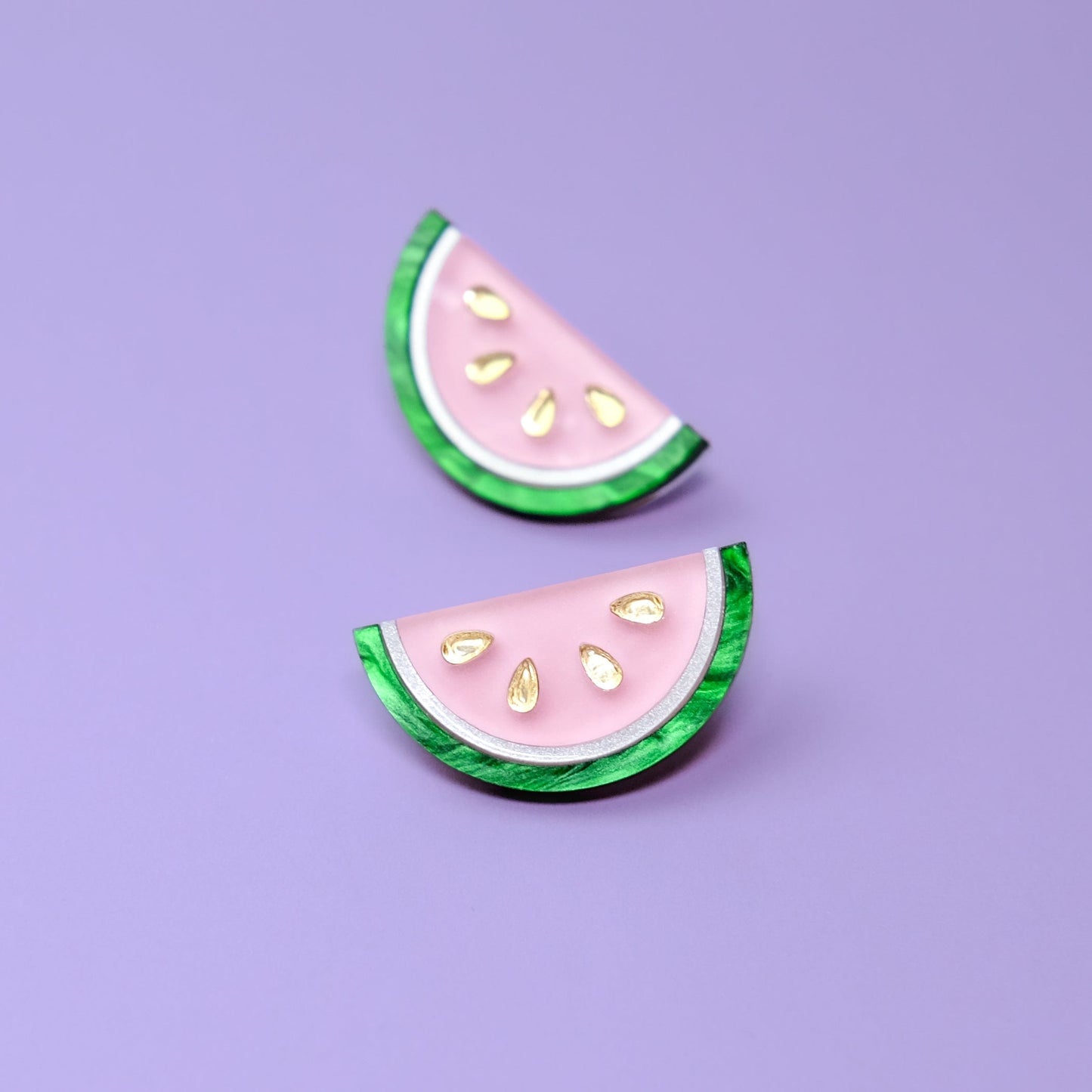 Watermelon slice stud earrings, glossy, lightweight, pink semi-circles with marbled green rind and gold seeds #color_pink-green