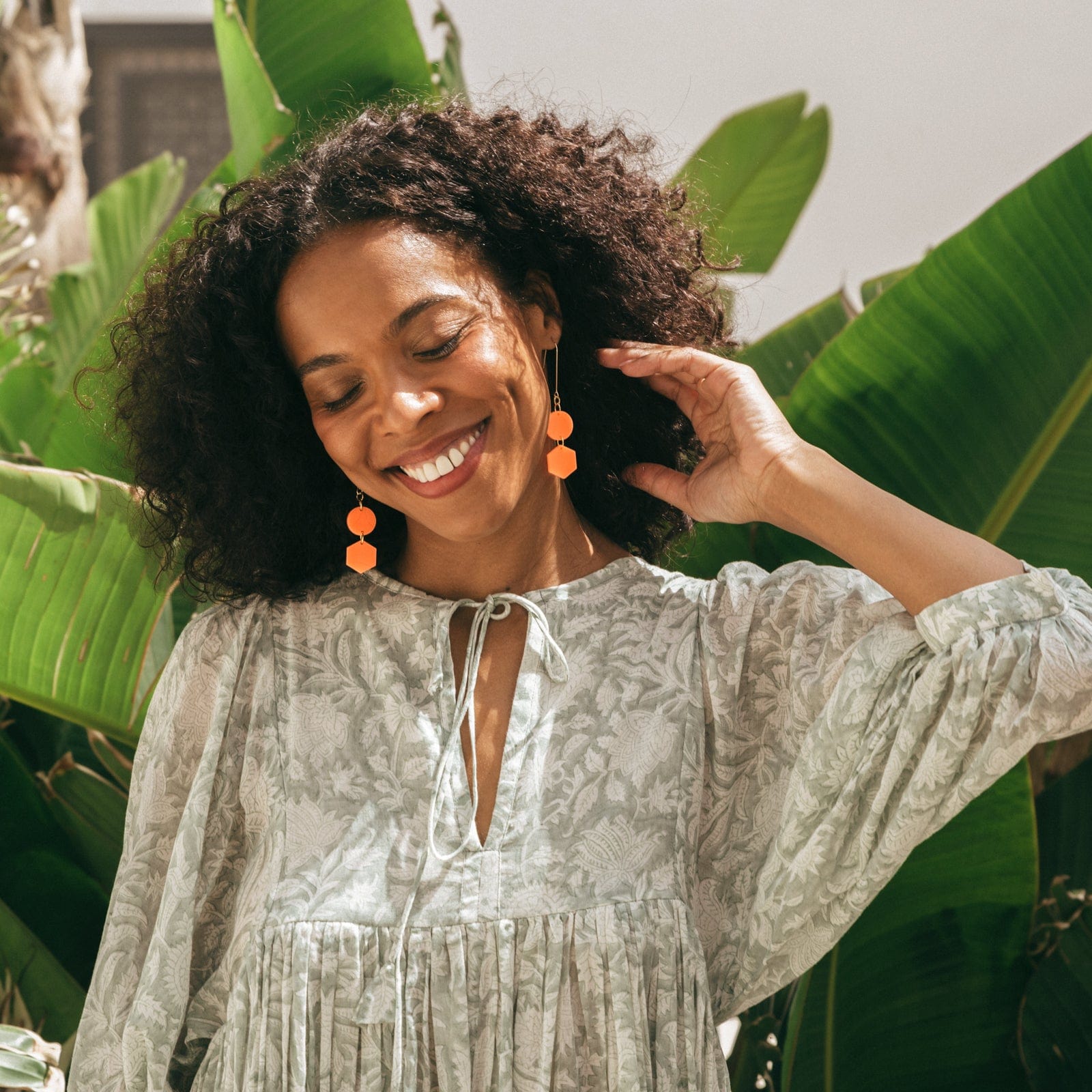 Elegant, elongated and lightweight Belle Dangles geometric dangly earrings in bright neon orange #color_neon-orange