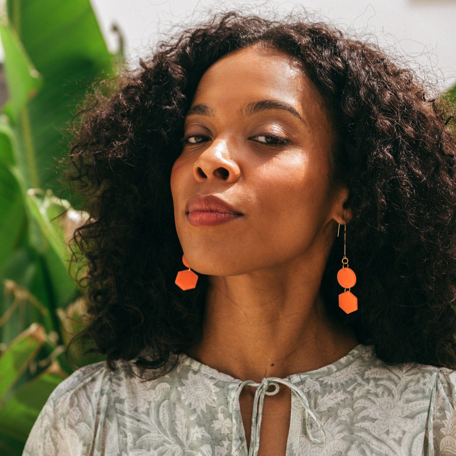 Elegant, elongated and lightweight Belle Dangles geometric dangly earrings in bright neon orange #color_neon-orange