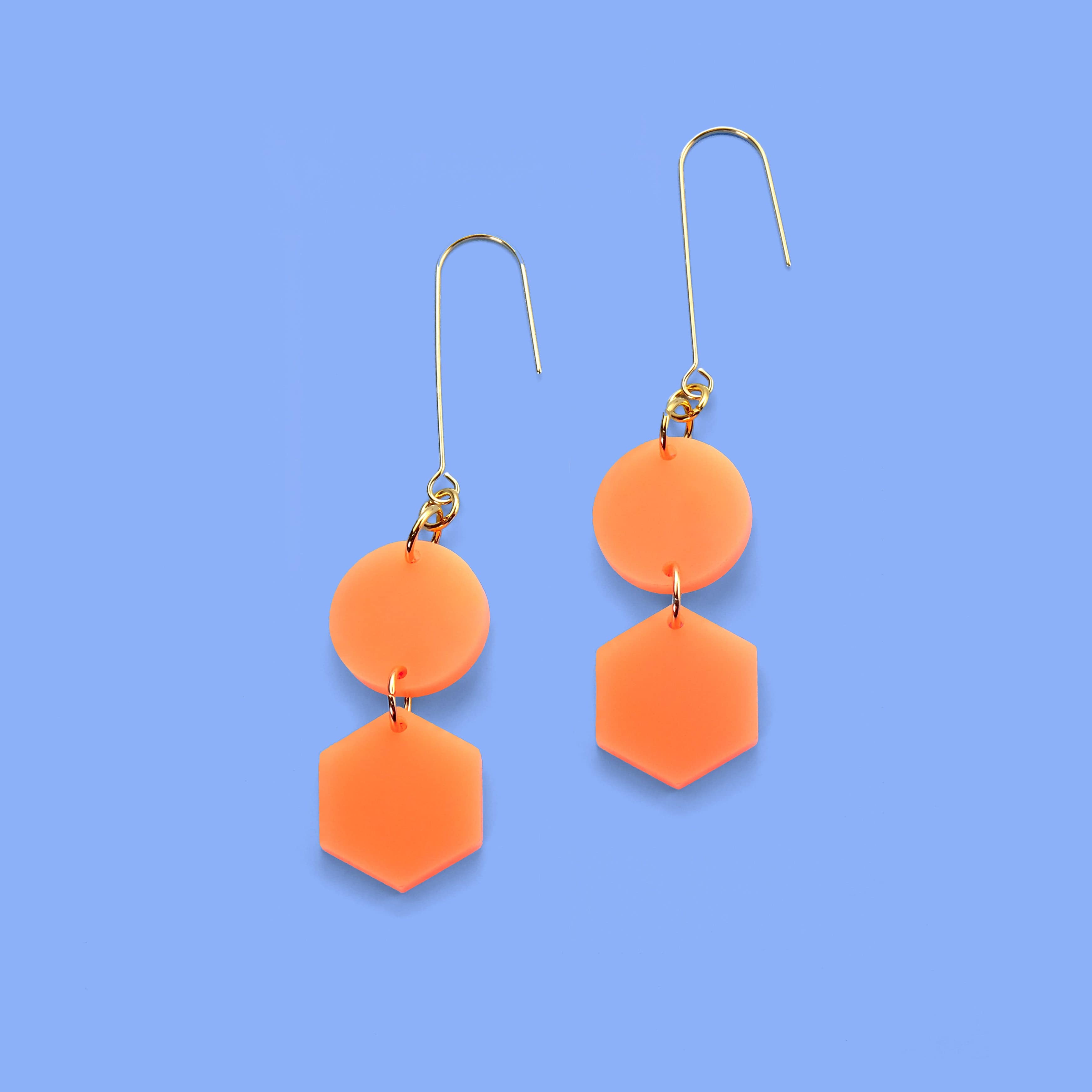 Elegant, elongated and lightweight Belle Dangles geometric dangly earrings in bright neon orange #color_neon-orange