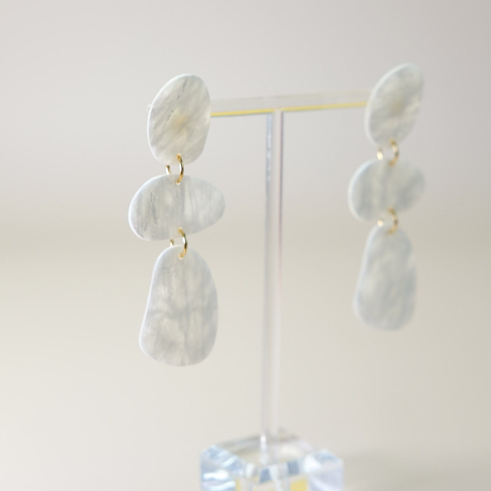 Hand-made mother of pearl terrazzo dangly statement earrings #color_white-translucent-marble