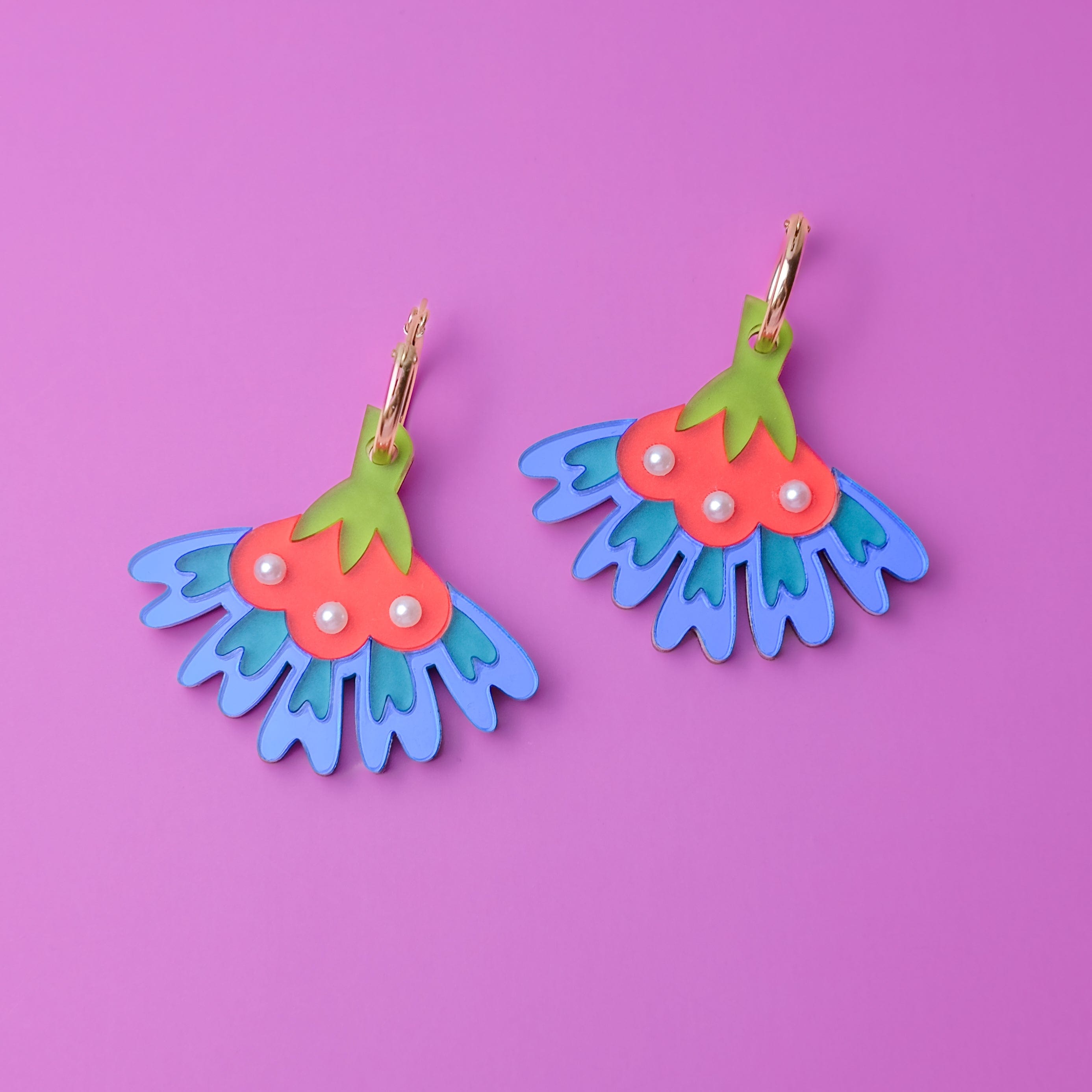 cosmos flower dangly hoop earrings in blue #color_blue