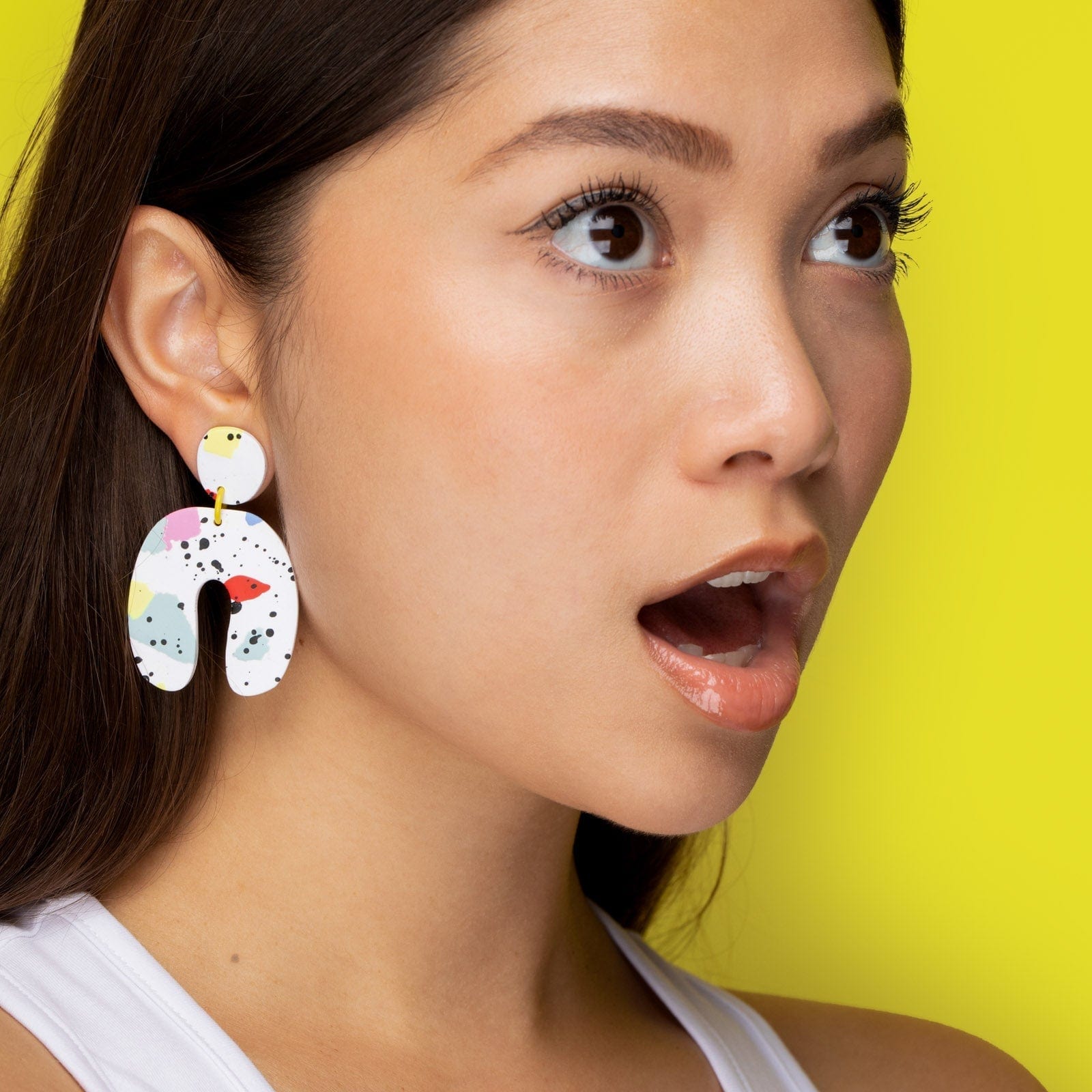 Dangly Arches Earrings in colorful paint splatter #color_paint-splatter