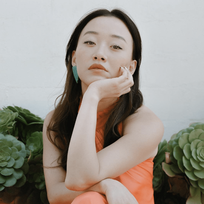 Gia Kim wearing By Chavelli Dagger earrings in turquoise