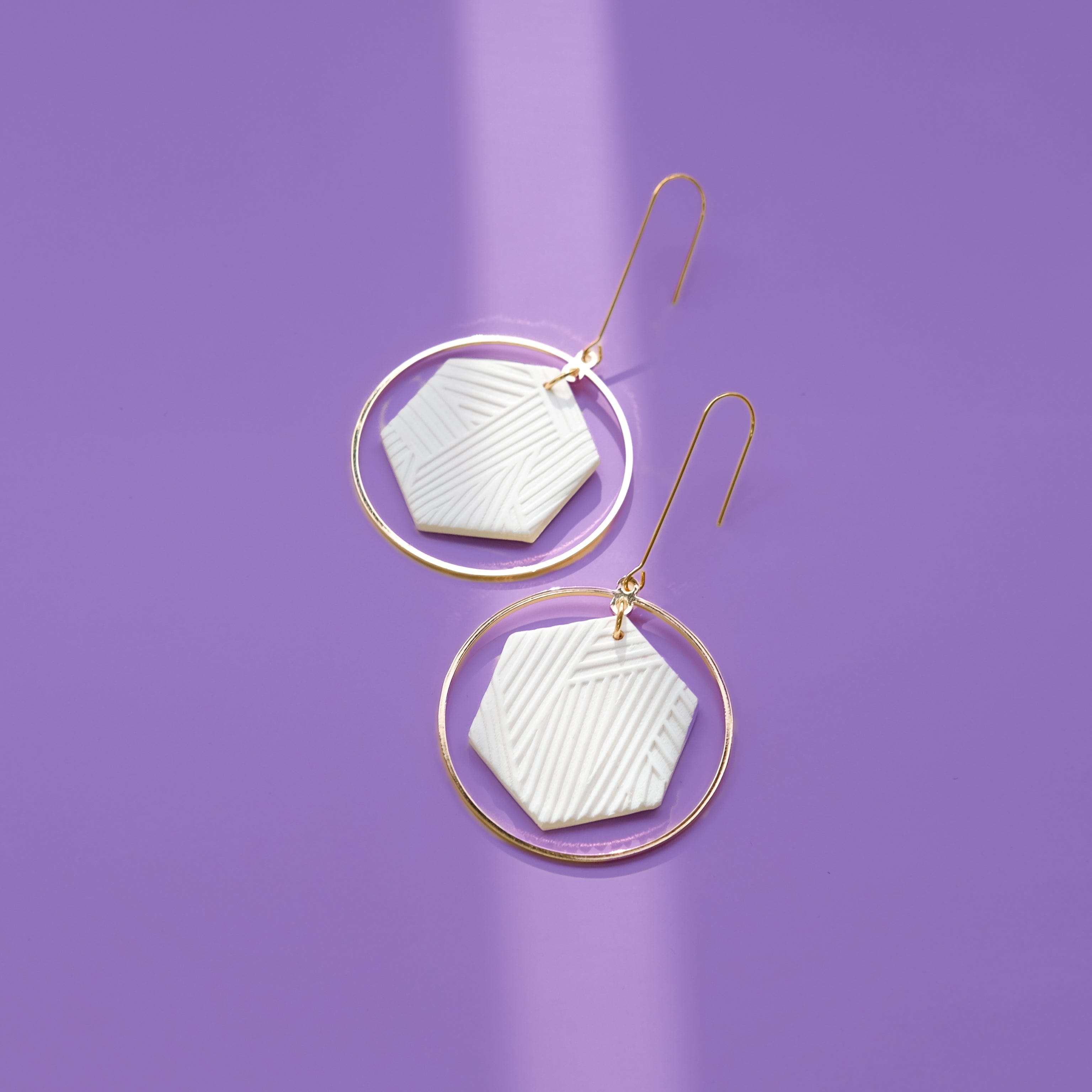 Hex Halo Dangly hexagon shaped white and gold earrings #color_white-textured-lines