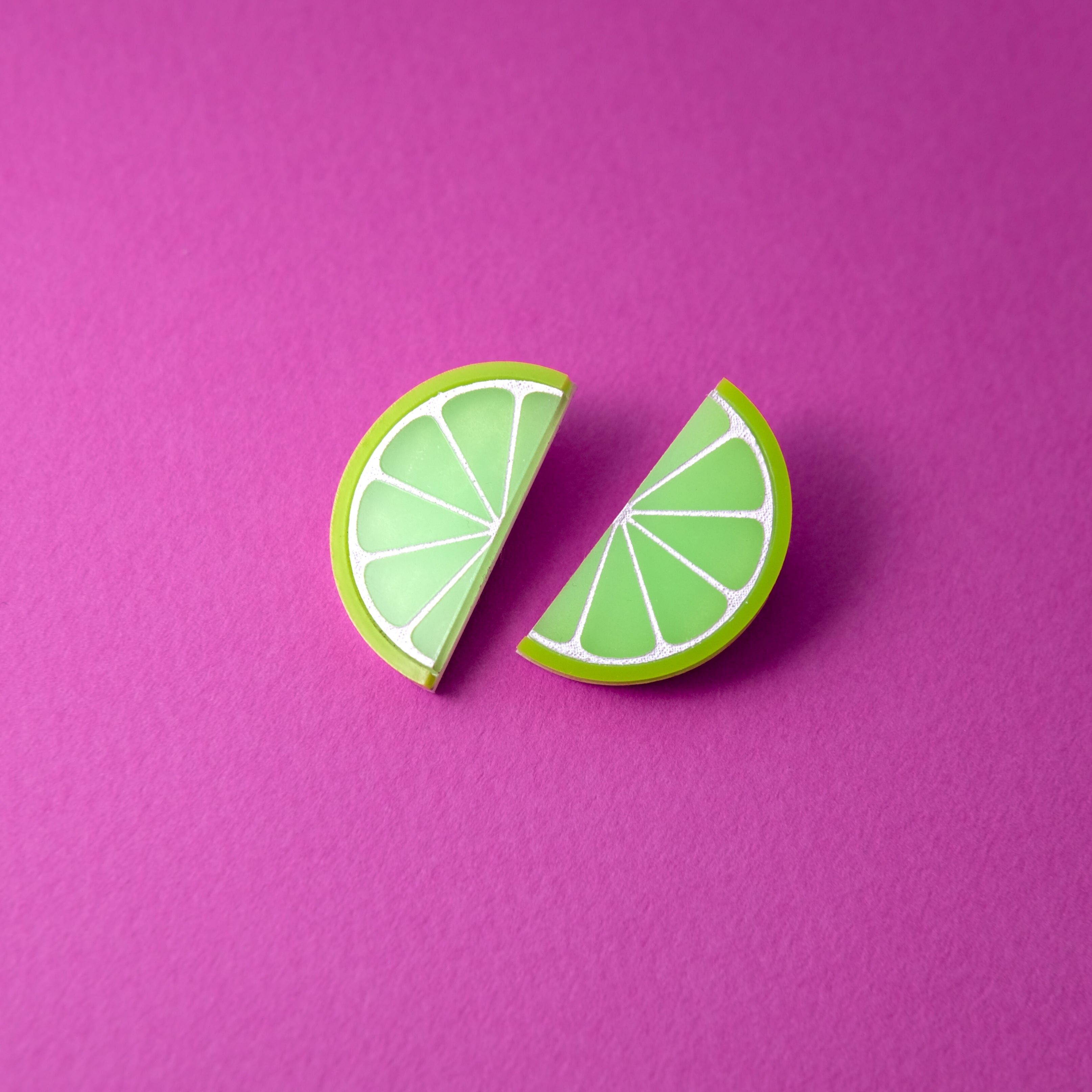 Lime slice stud earrings, glossy, lightweight, playful, citrus half-moons with white segment lines #color_green-white