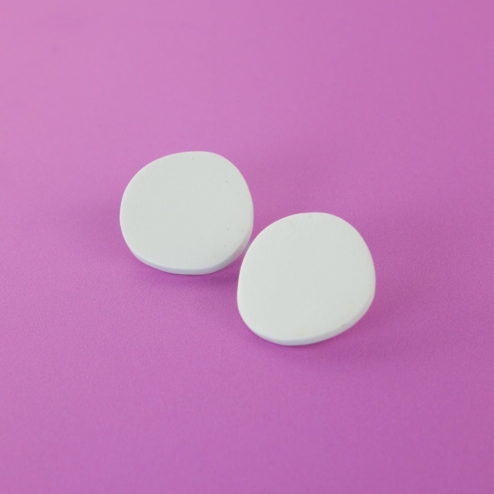 Miro inspired organic round shaped studs with canvas texture in white #color_white