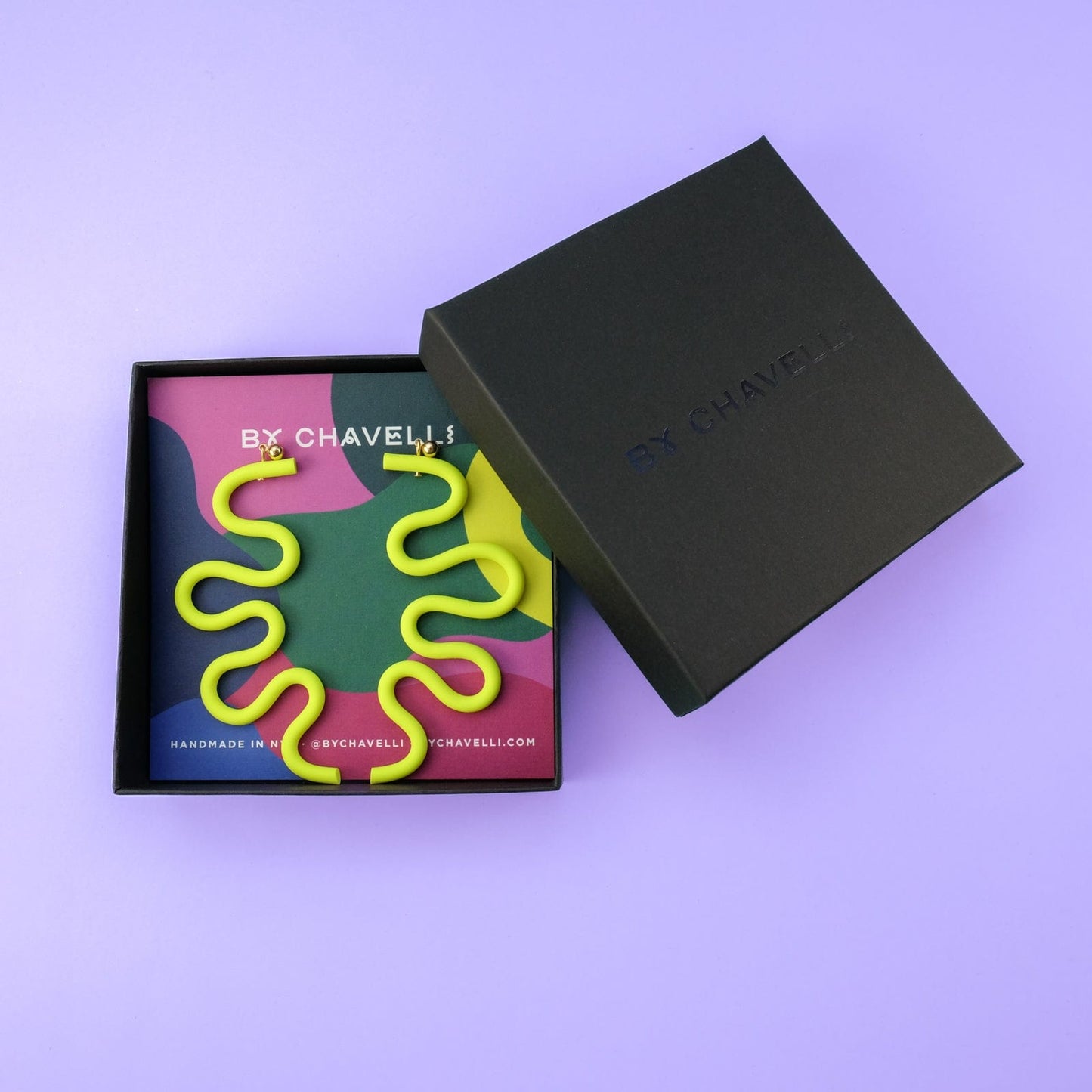 Tube Squiggle dangly statement earrings small in neon yellow #color_neon-yellow