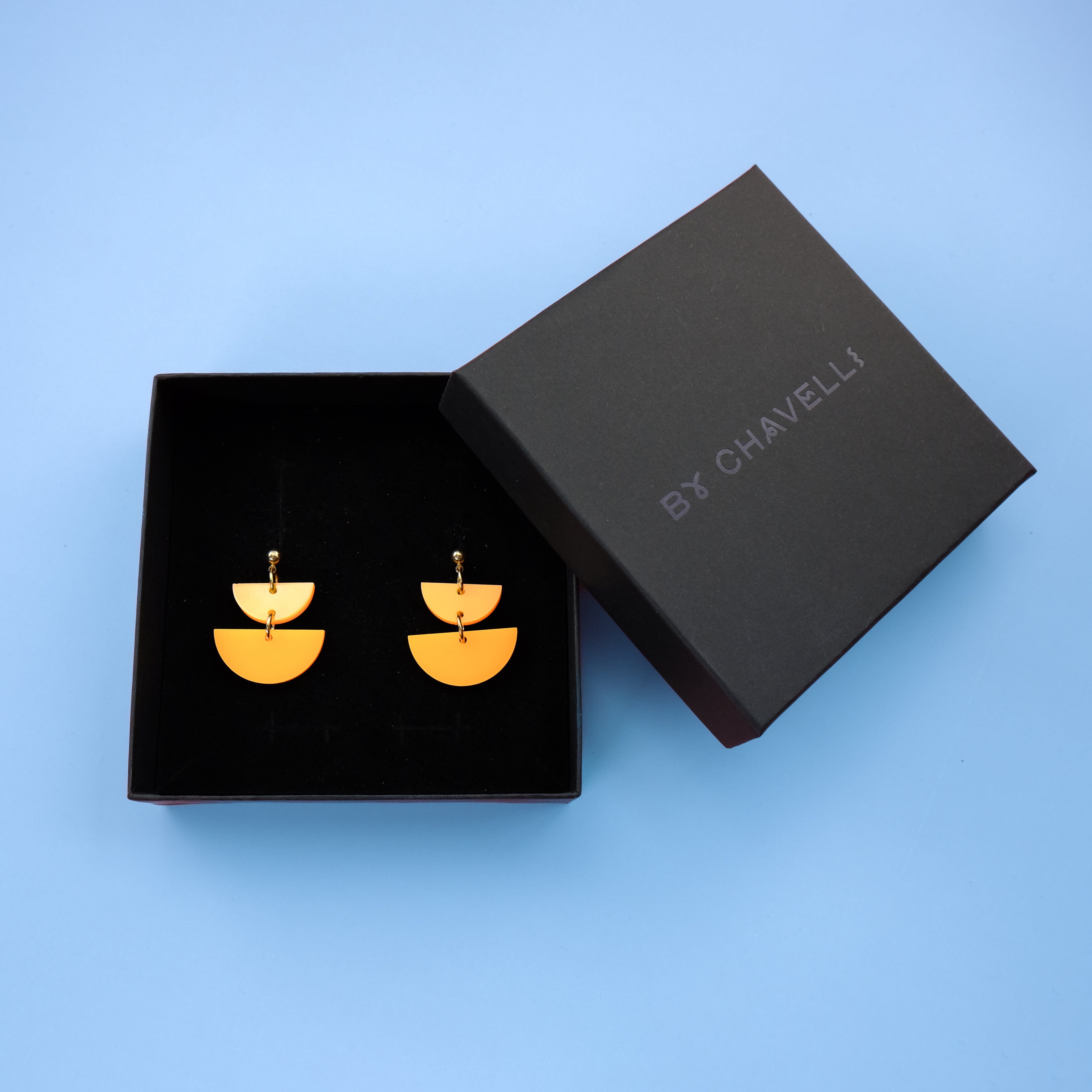Twin Luna cute dangly half-moon shaped earrings in neon orange #color_neon-orange