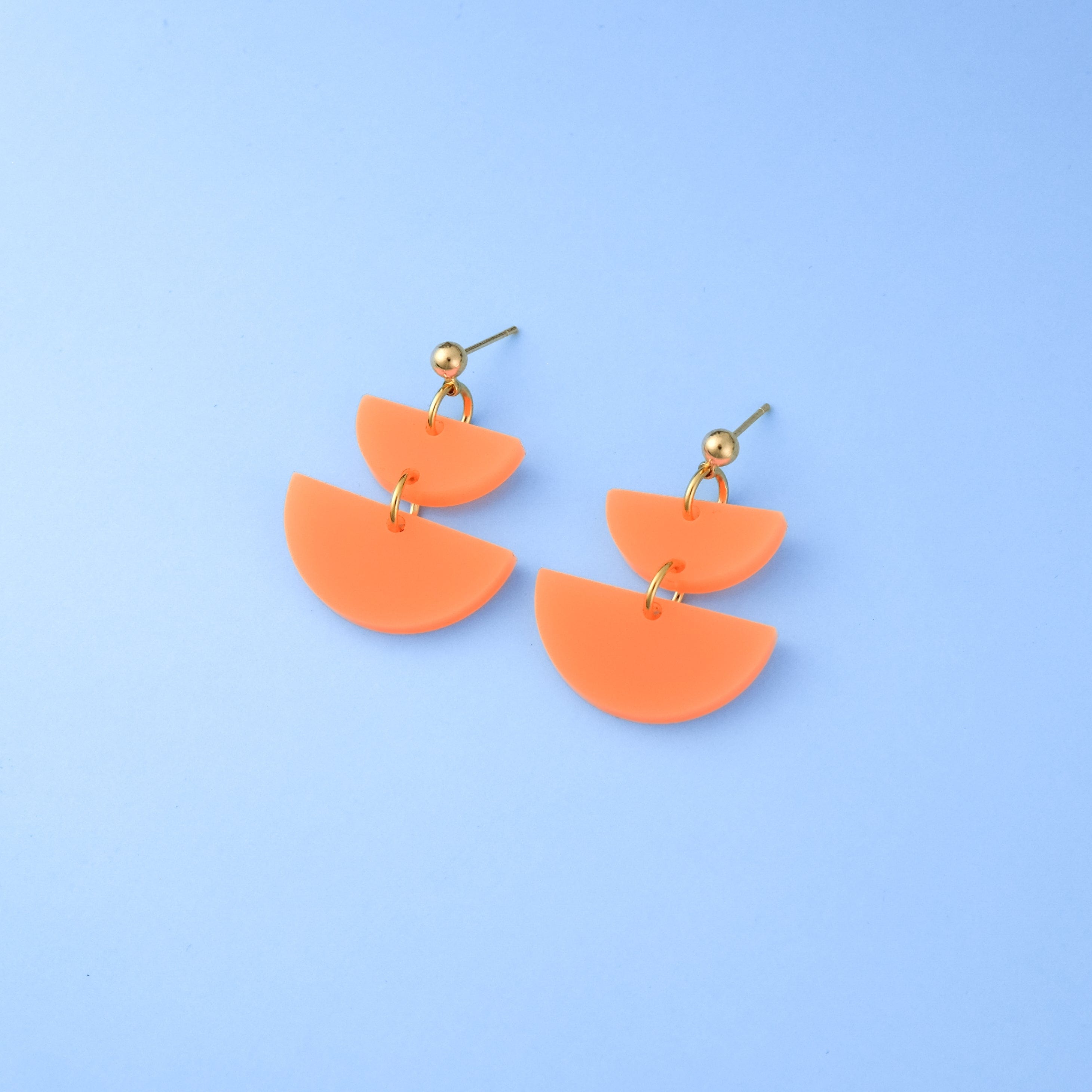 Twin Luna cute dangly half-moon shaped earrings in neon orange #color_neon-orange